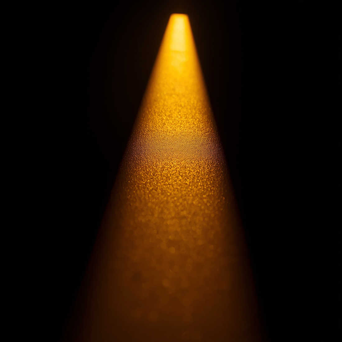 Warm sunlight across a dark surface, a reminder to store perfume away from heat and light